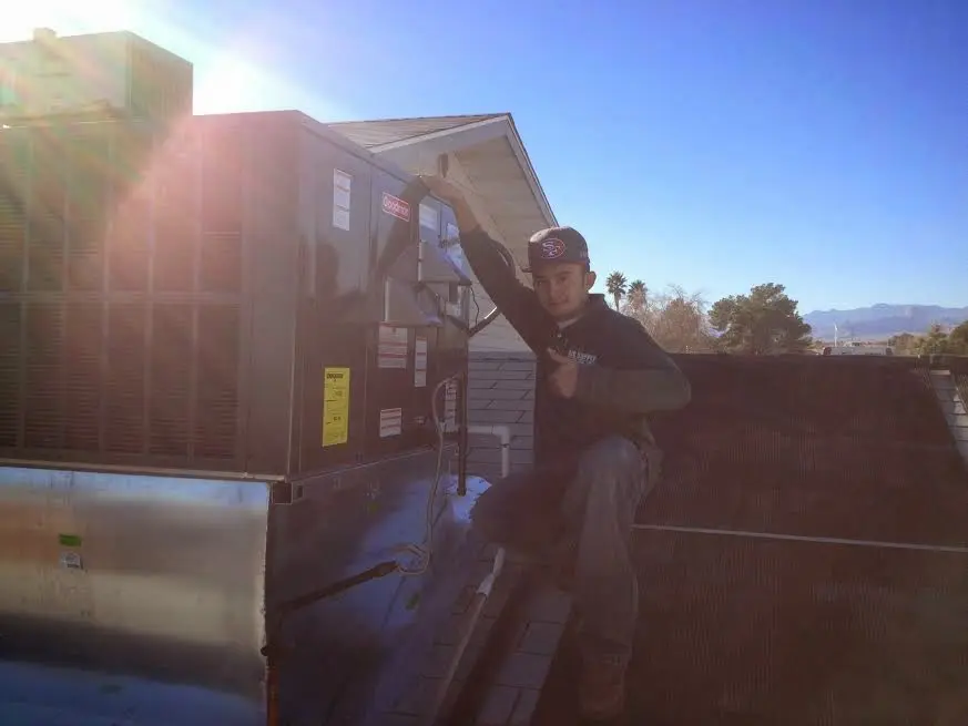 HVAC technician performing Boiler Repair on a rooftop unit in Dublin